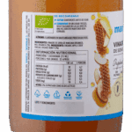 Tabla de información nutricional del Vinagre de Sidra de Manzana Manare con Miel Orgánica 500ml. Muestra valores de energía (31 kcal/100ml, 4.7 kcal/porción), proteínas, grasas, carbohidratos (3.5g azúcares/100ml) y sodio. Ingredientes: Vinagre de sidra de manzana orgánico, miel orgánica (2%). Advertencia de alérgenos: "Elaborados en una planta que procesa sulfitos".